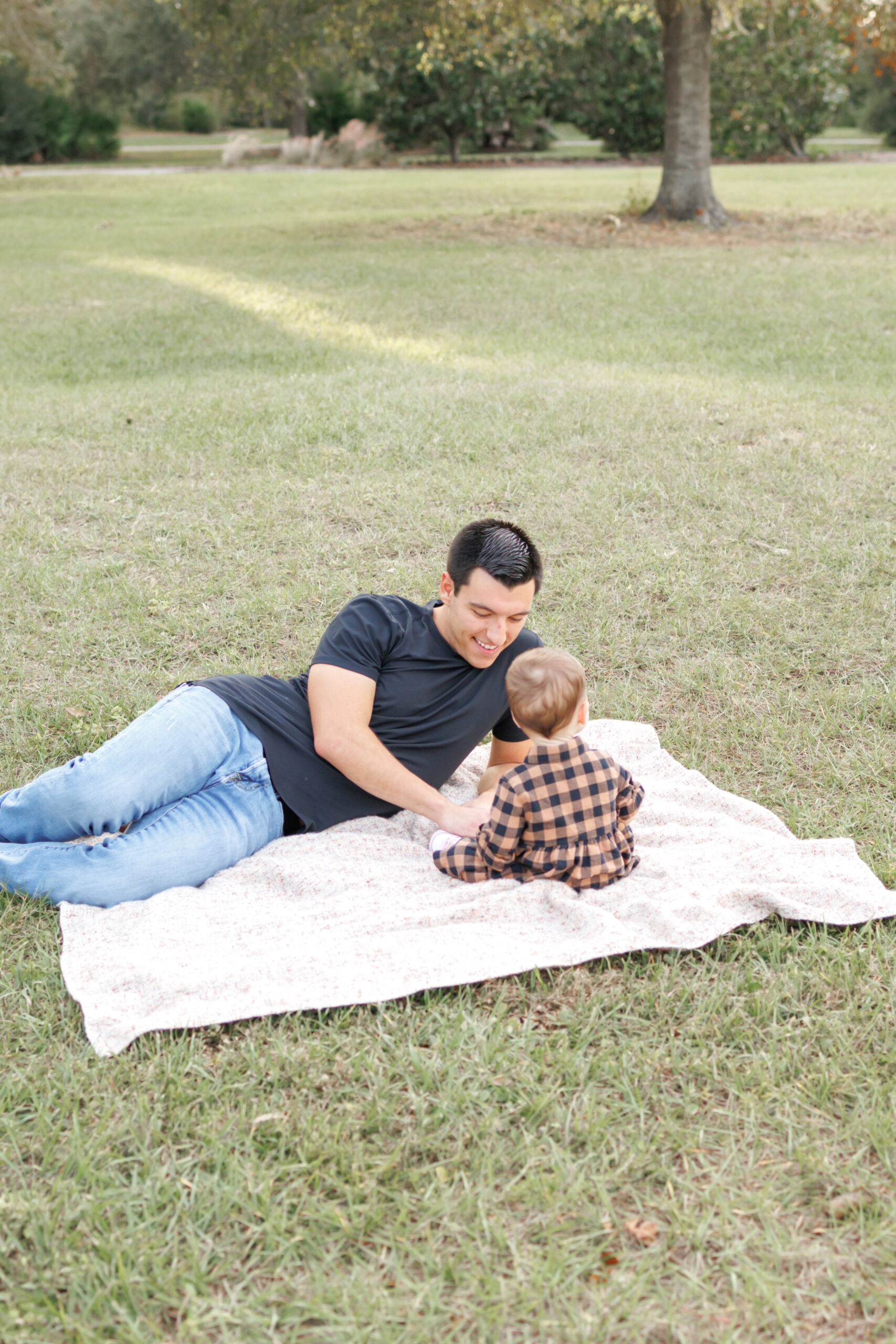 Lifestyle photography portrait of dad and daughter at park taken by Huntsville photographer