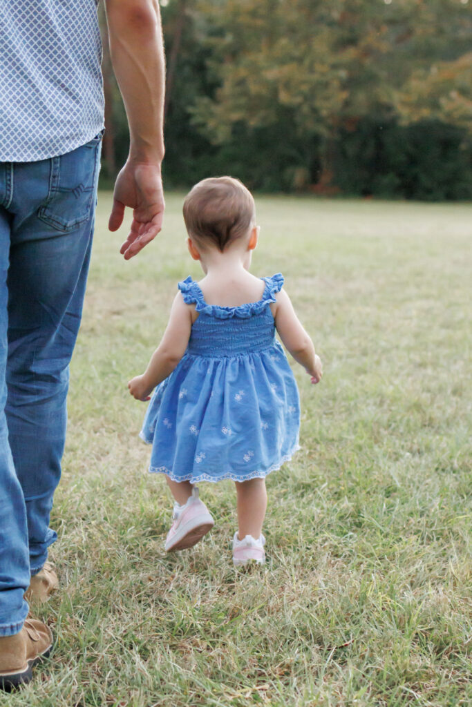 Lifestyle photography of dad and daughter walking